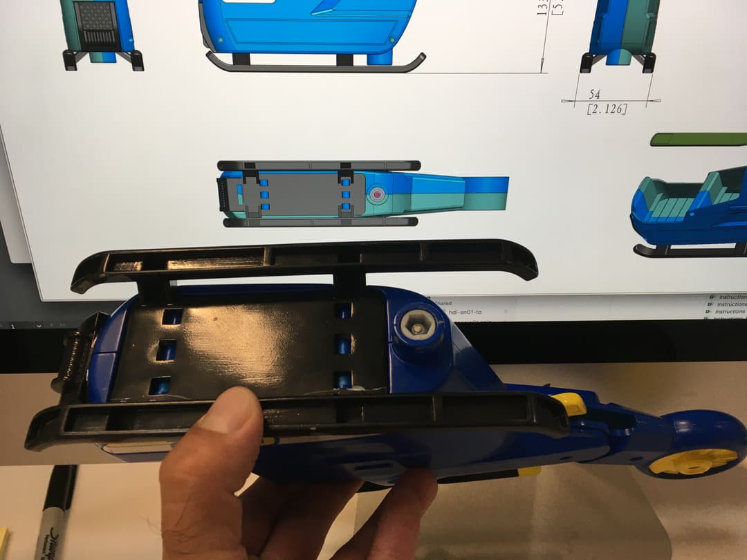 Quality control check comparing a finished physical toy sample against its CAD model